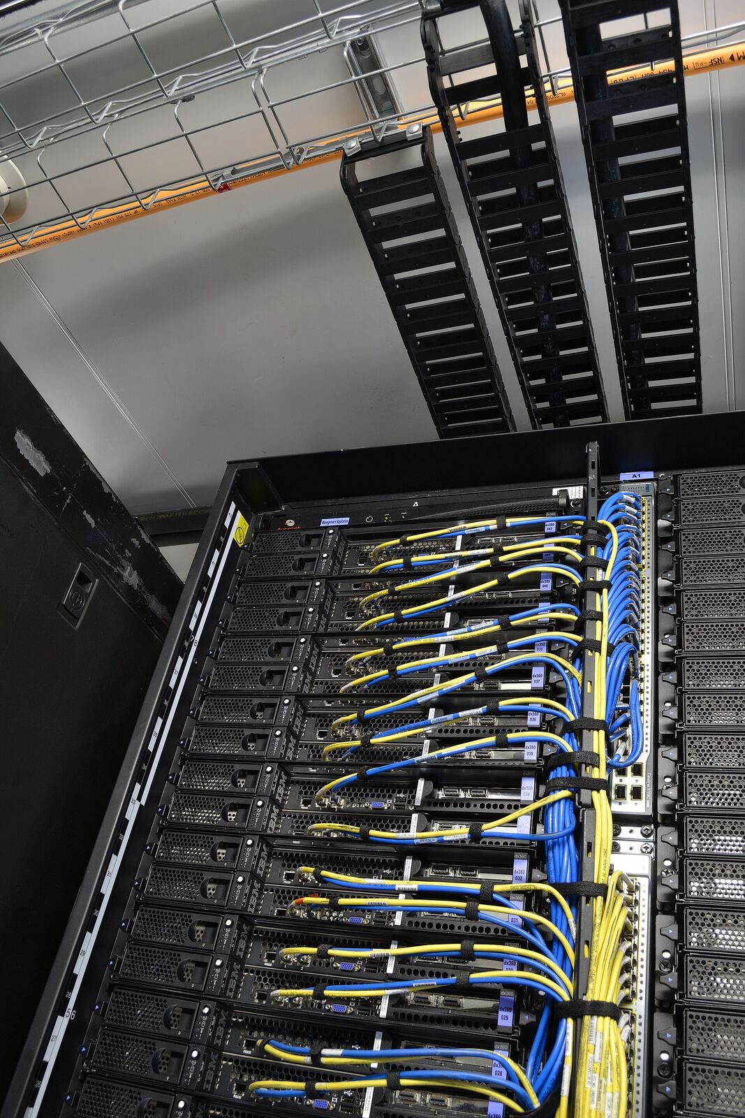 IBM Portable Modular Data Center - power, network cable rails into the server rack (high-density iDataPlex rack).