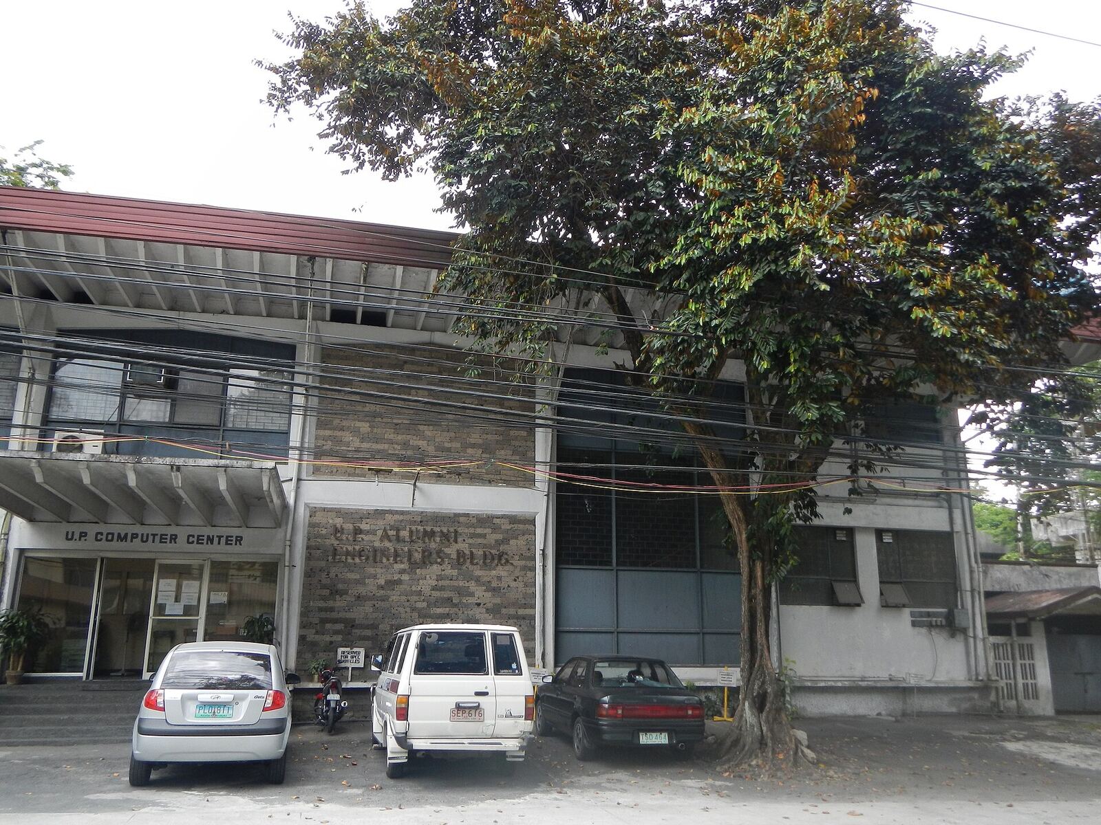 University of the Philippines Computer Center [1] The U.P. Computer Center is an independent unit of the Diliman campus [2] of the University of the Philippines [3] that provides high-speed computer and information technology services to the University faculty, administration and students. It is now under the Office of the Chancellor of UP Diliman It is housed in the UP Alumni Engineers (UPAE) Building at the back of the Melchor Hall compound. Also called the UP CC (or CC for short), the facility serves as the central hub that interconnects the fiber-optic backbones in UP Diliman and other UP campuses. The center is also the hub of the UP Diliman Wireless Network, which has over 100 WiFi Hot Spots deployed all over the campus as of 2011. The center is administered by a member of the faculty and manned by full-time employees and student assistants. Its current director is Dr. Johnrob Y. Bantang from the National Institute of Physics. [4] [5] The Computer Center and its staff during the 1970s The University Computer Center was established in September 15, 1966 by the University of the Philippines In 2011, the University Computer Center implemented the largest IPv6 network and one of the first in the country. The University Computer Center in Diliman maintains one of the largest campus networks in the country, having laid more than 50 kilometers of fiber optic cables, deploying over 100 wireless hotspots, 1024 Voice over IP (VoIP) phones, and hosting around 80 UP websites through its servers. University Computer Center is divided into 3 units namely: Administrative Unit Data Processing Unit Network and Systems Operation Unit [6] Coordinates: 14°39'26"N 121°4'12"E [7] [8]